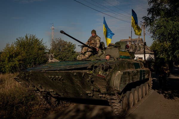 Ukrainian soldiers riding in a captured Russian military vehicle in Velyka Oleksandrivka last week.