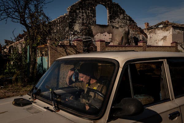 A Ukrainian soldier outside a destroyed home in the village last week.