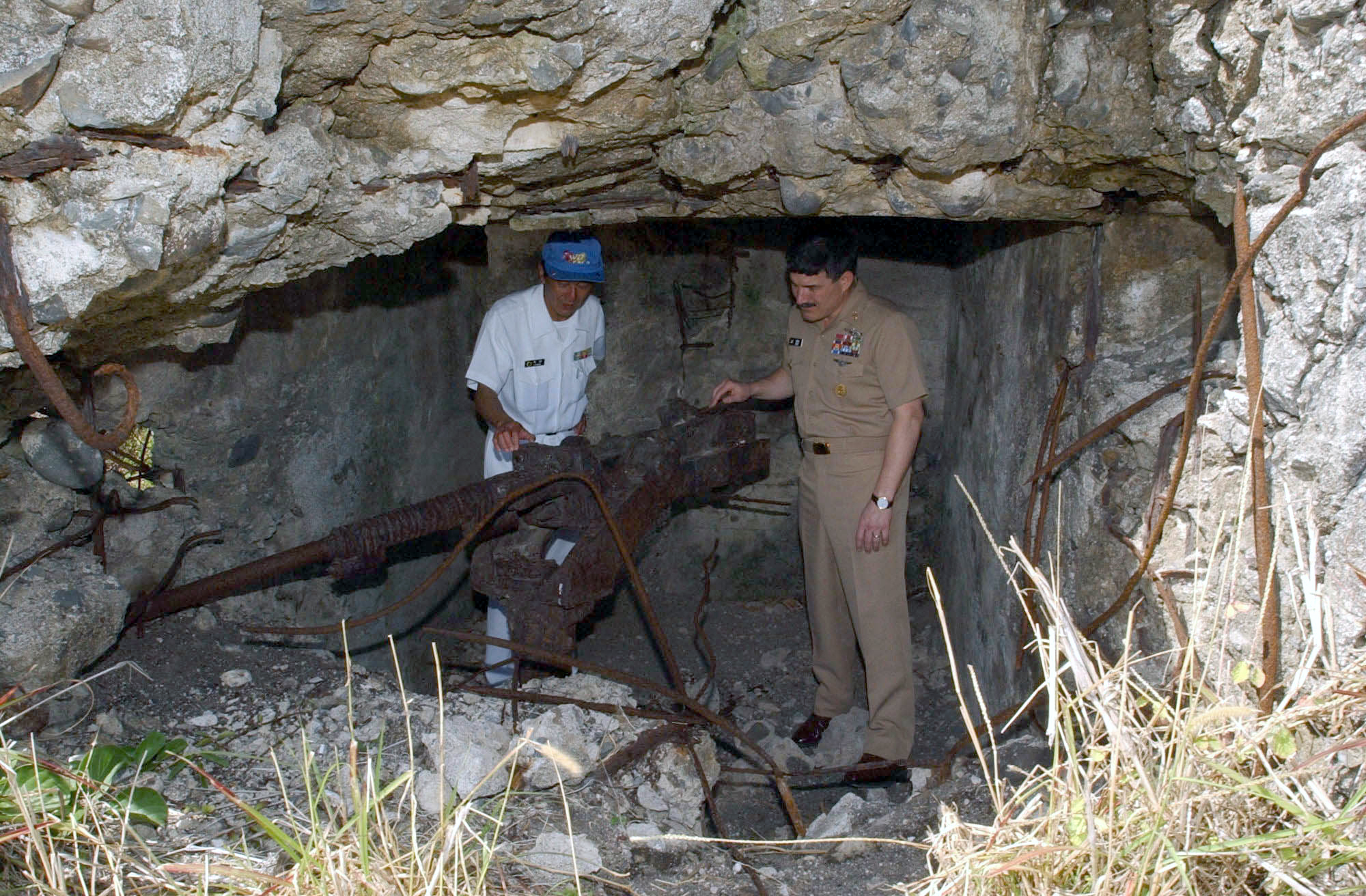 US_Navy_030323-N-0252D-003_Master_Chief_Petty_Officer_of_the_Navy_Terry_D._Scott_inspects_an_old_Japanese_machine_gun_nest_that_still_faces_the_beachhead_where_U.S._Marines_landed_during_the_Battle_of_Iwo_Jima.jpg