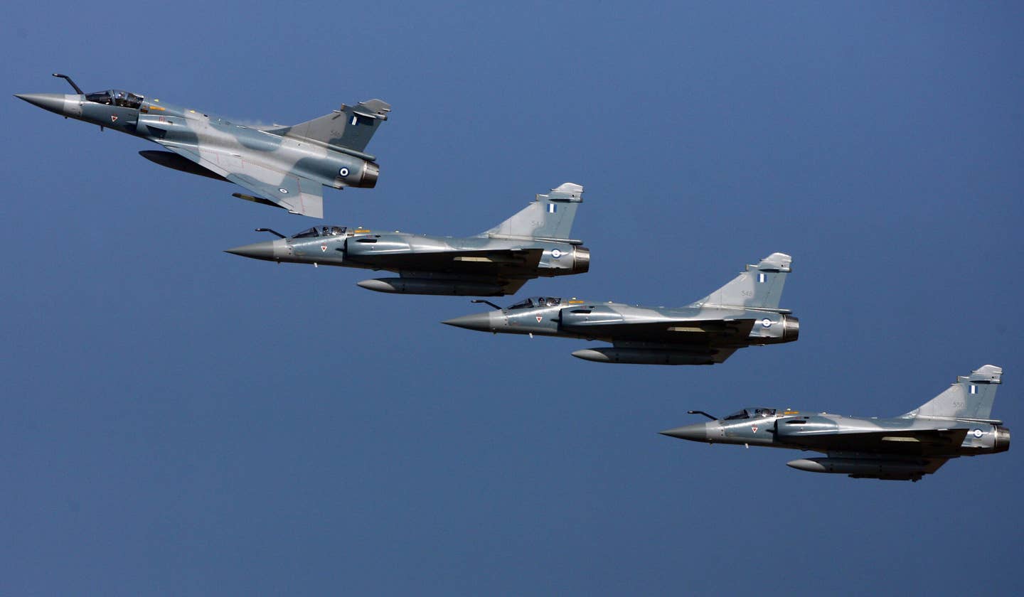 A four-ship of Hellenic Air Force Mirage 2000-5s over the airbase of Tanagra, north of Athens, in November 2007, during a commissioning ceremony for the jets. <em>ARIS MESSINIS/AFP via Getty Images</em>