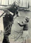 East_German_soldier_helps_a_little_boy_1961.jpg