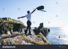 stock-photo-man-throws-up-a-backpack-on-the-background-of-the-ruins-of-the-fort-1220783116.jpg