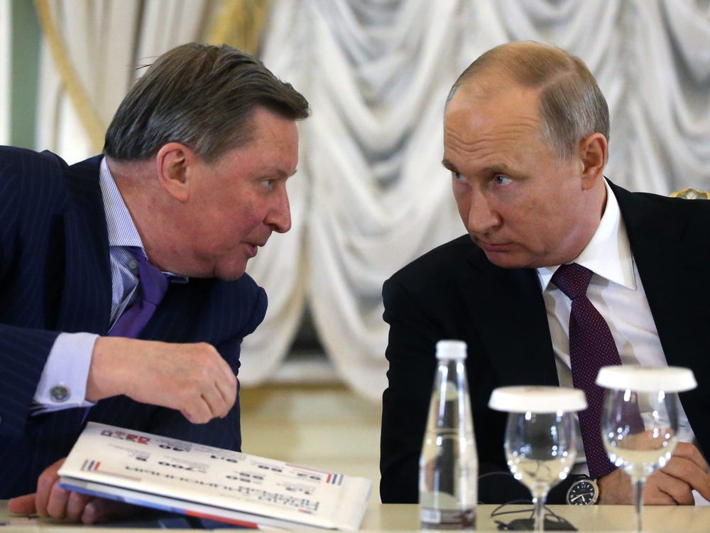 Russian President Vladimir Putin (R) listens to his Special Envoy on Ecology Sergei Ivanov (L) during a meeting with foreign investors at the 2018 Saint Petersburg International Economic Forum.