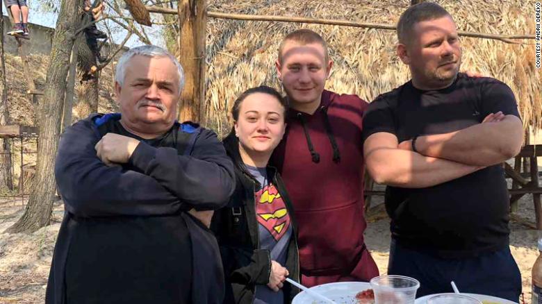Karina Yershova is pictured with her grandfather, left and stepfather Andrii Dereko, far right.