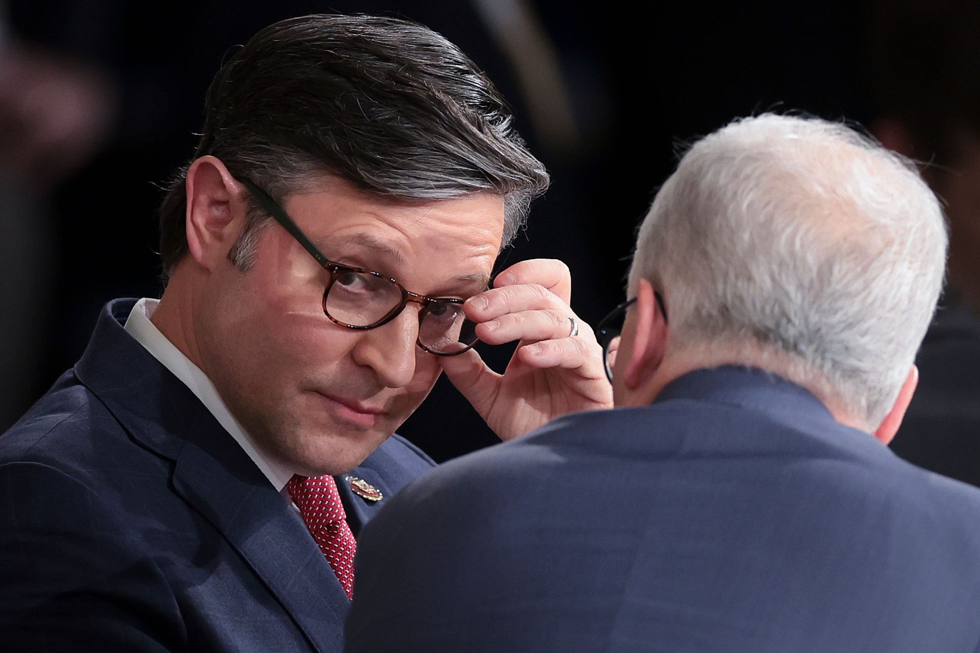 Speaker Mike Johnson speaks with Rep. Patrick McHenry in the House chamber of the Capitol after Johnson was elected by the House to become Speaker on October 25.