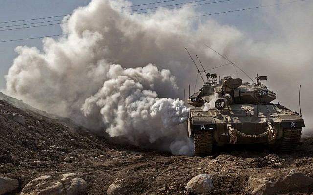 An IDF Merkava tank drives near the border with Syria on the Golan Heights on November 28, 2016. (AFP Photo/Jack Guez)