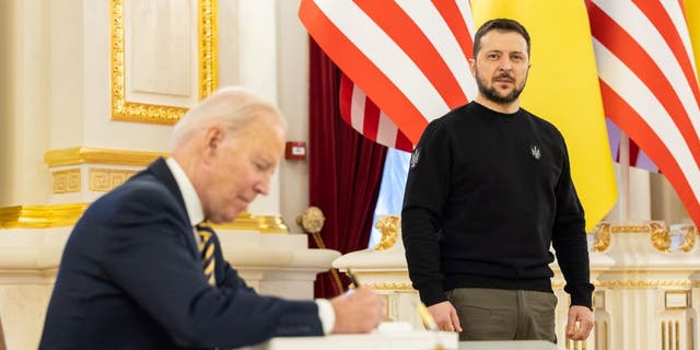 President Biden signs the guest book during a meeting with Ukrainian President Volodymyr Zelensky at the Ukrainian presidential palace on Feb. 20, 2023 in Kyiv, Ukraine. Biden made his first visit to Kyiv since Russia's large-scale invasion last Feb. 24.