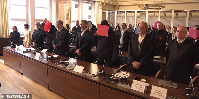 Nine attackers - who were aged between 16 and 20 - were found guilty of raping a girl in a Hamburg park in 2020. Pictured: The defendants stand next to their lawyers at the rape trial