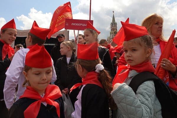 Children who are part of the Russian Young Pioneers gather wearing red scarves and hats for an induction ceremony at Red Square in Moscow in May.
