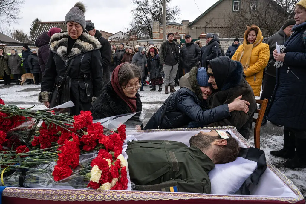 Loved ones at the funeral of a Ukrainian soldier, Anton Pushkar, who died in the fighting near Bakhmut, in Kharkiv on Monday.