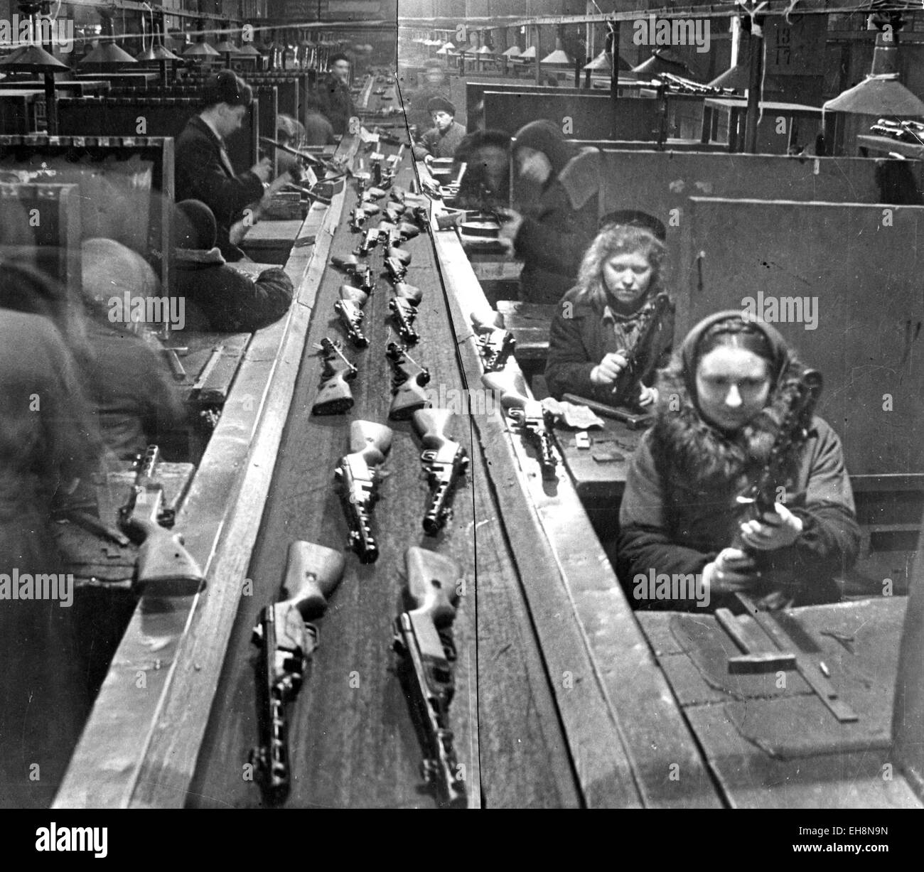 SOVIET ARMAMENTS Women workers fitting out  PPSH-41 submachine guns on a factory production line about 1943 Stock Photo
