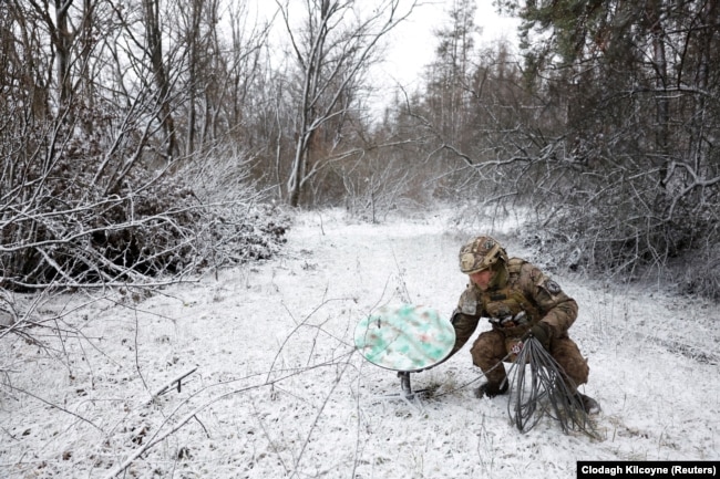 A Ukrainian military man installs an antenna for the Starlink system, Kremennaya, Donetsk region of Ukraine. January 6, 2023