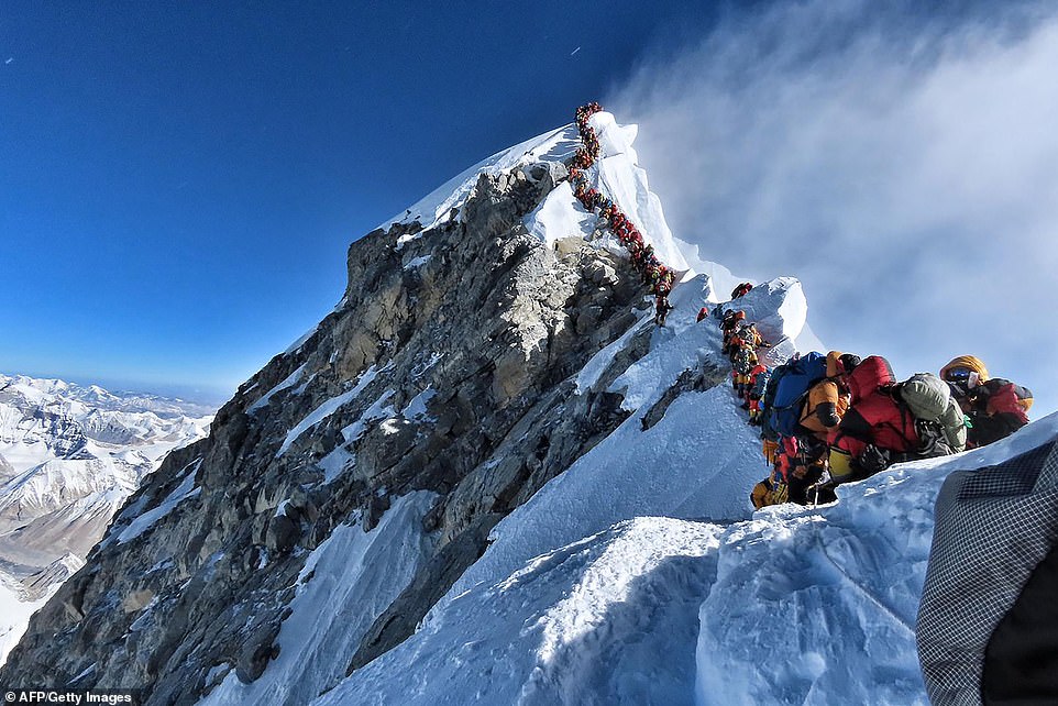 Massive line: In this picture taken on Sunday May 22, hundreds of mountain climbers line up to stand at the summit of Mount Everest Many teams waited for hours to reach the summit, risking frostbites and altitude sickness