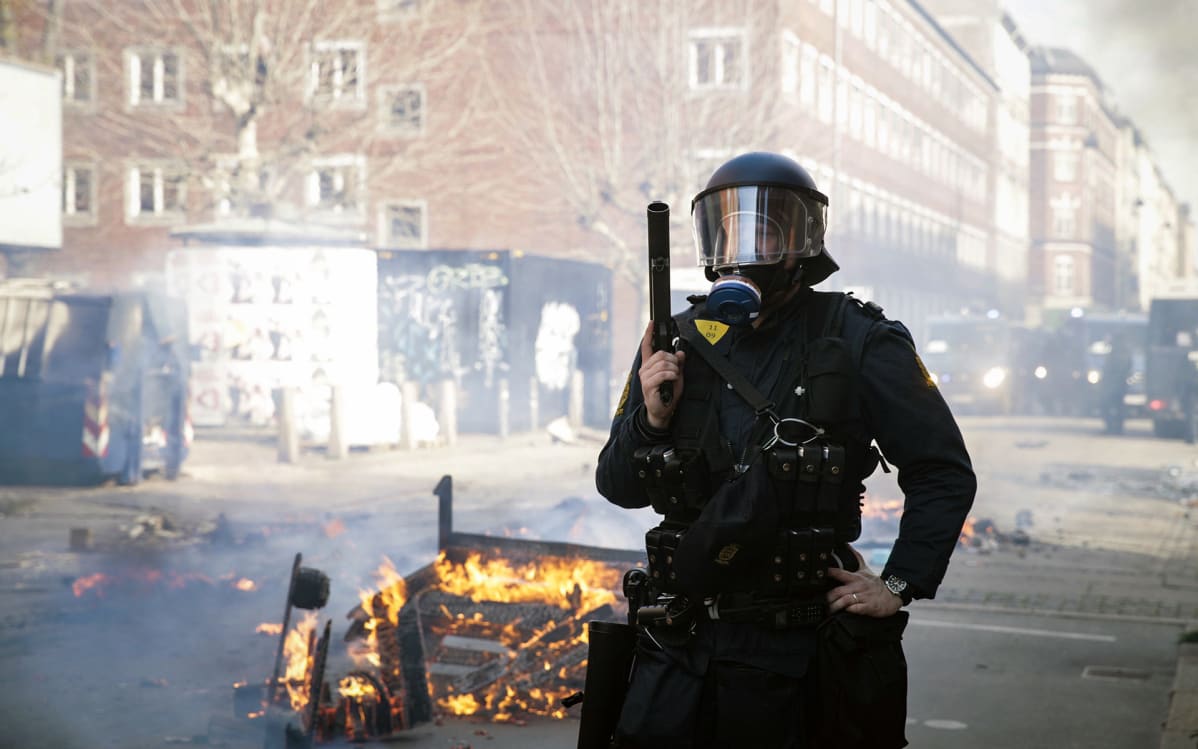 Poliisi vartioimassa mielenosoituksen jälkeen Nørrebrossa, Kööpenhaminassa sunnuntaina.