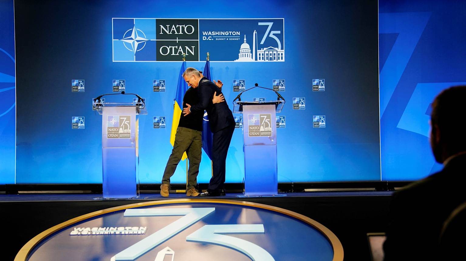 Volodymyr Zelenskyi ja Jens Stoltenberg halaavat Nato-kokouksen pressitilan lavalla. Volodymyr Zelenskyi ja Jens Stoltenberg halaavat Nato-kokouksen pressitilan lavalla.