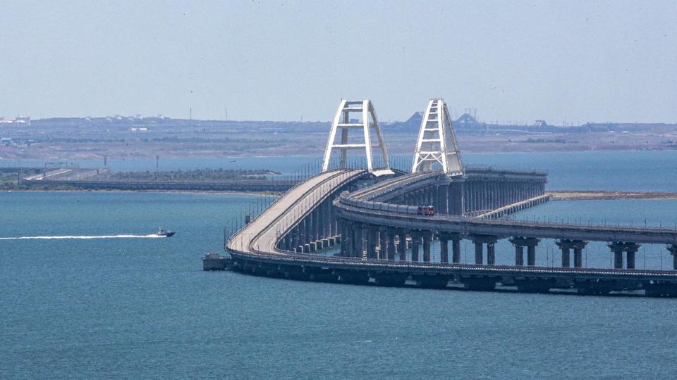 A freight train passes over the Crimean Bridge railway link, which connects mainland Russia and the Crimean peninsula across the Kerch Strait (archive)