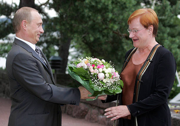 turku-finland-russian-president-vladimir-putin-presents-flowers-to-picture-id53312691