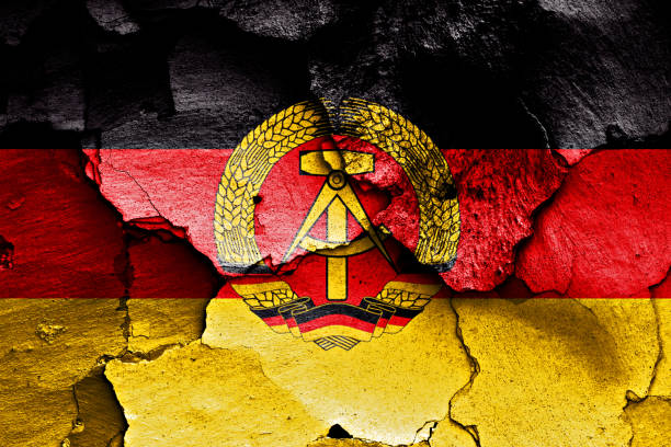 flag-of-east-germany-painted-on-cracked-wall-picture-id1263565346