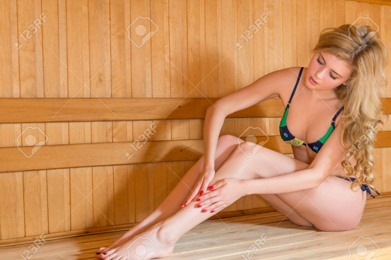 58822973-beautiful-girl-in-bikini-rubs-skin-cream-in-the-sauna-Stock-Photo.jpg